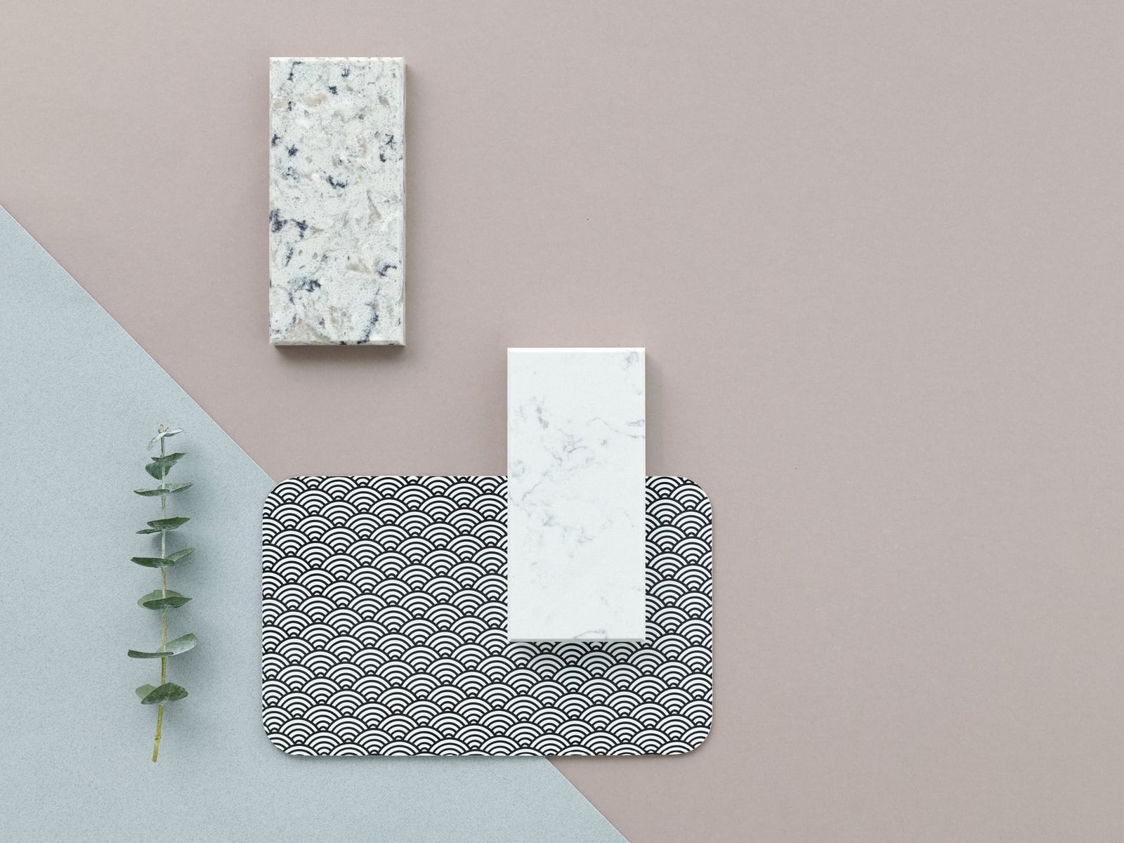 Various material samples of wood, acrylic, and metal on a workbench